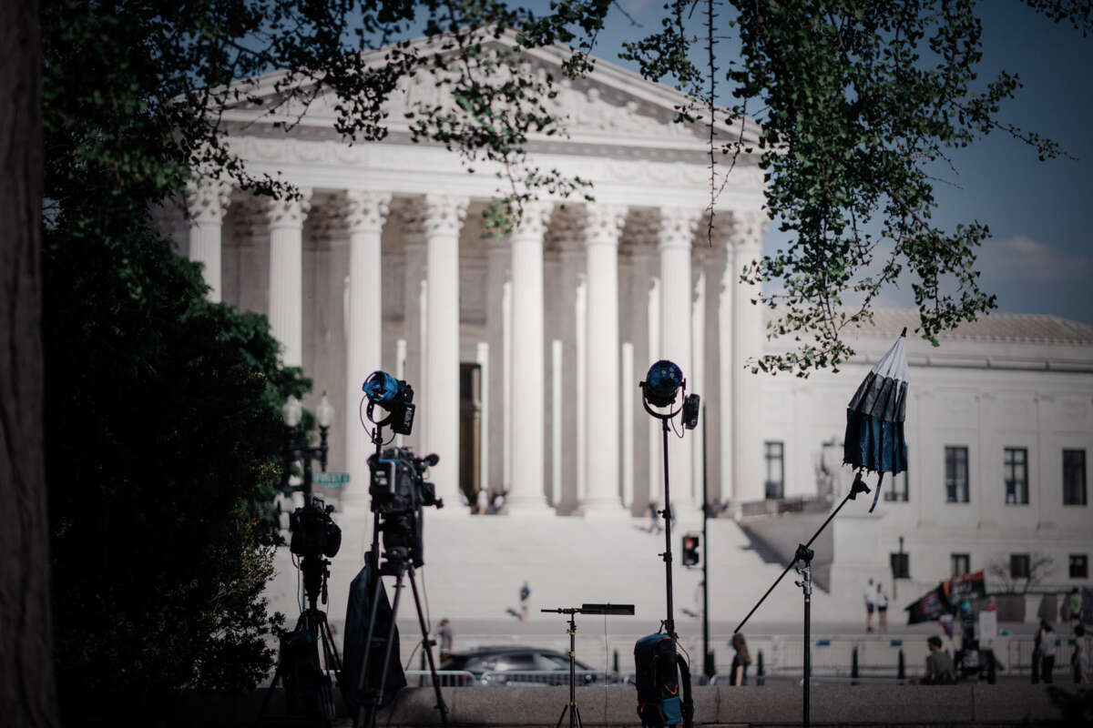 Camera crews set up for reporter interviews in front of the SCOTUS building