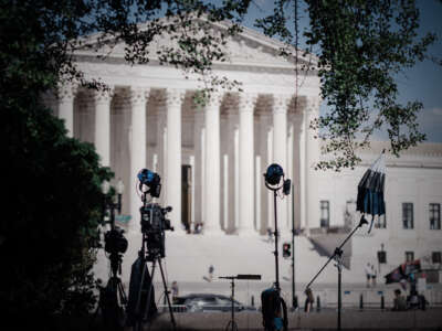 Camera crews set up for reporter interviews in front of the SCOTUS building