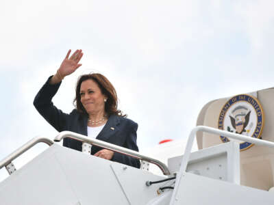 Vice President Kamala Harris makes her way to board a plane before departing from Andrews Air Force Base in Maryland on June 14, 2021.