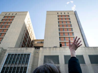 A protester waves toward prisoners at the Metropolitan Detention Center, on February 4, 2019, in Brooklyn, New York.