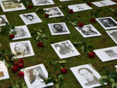 Pictures of people who were killed or went missing during the 1964-1985 dictatorship are layed out on the ground during a demonstration on the 58th anniversary of the military coup at Ibirapuera Park, in São Paulo, Brazil, on March 31, 2022.