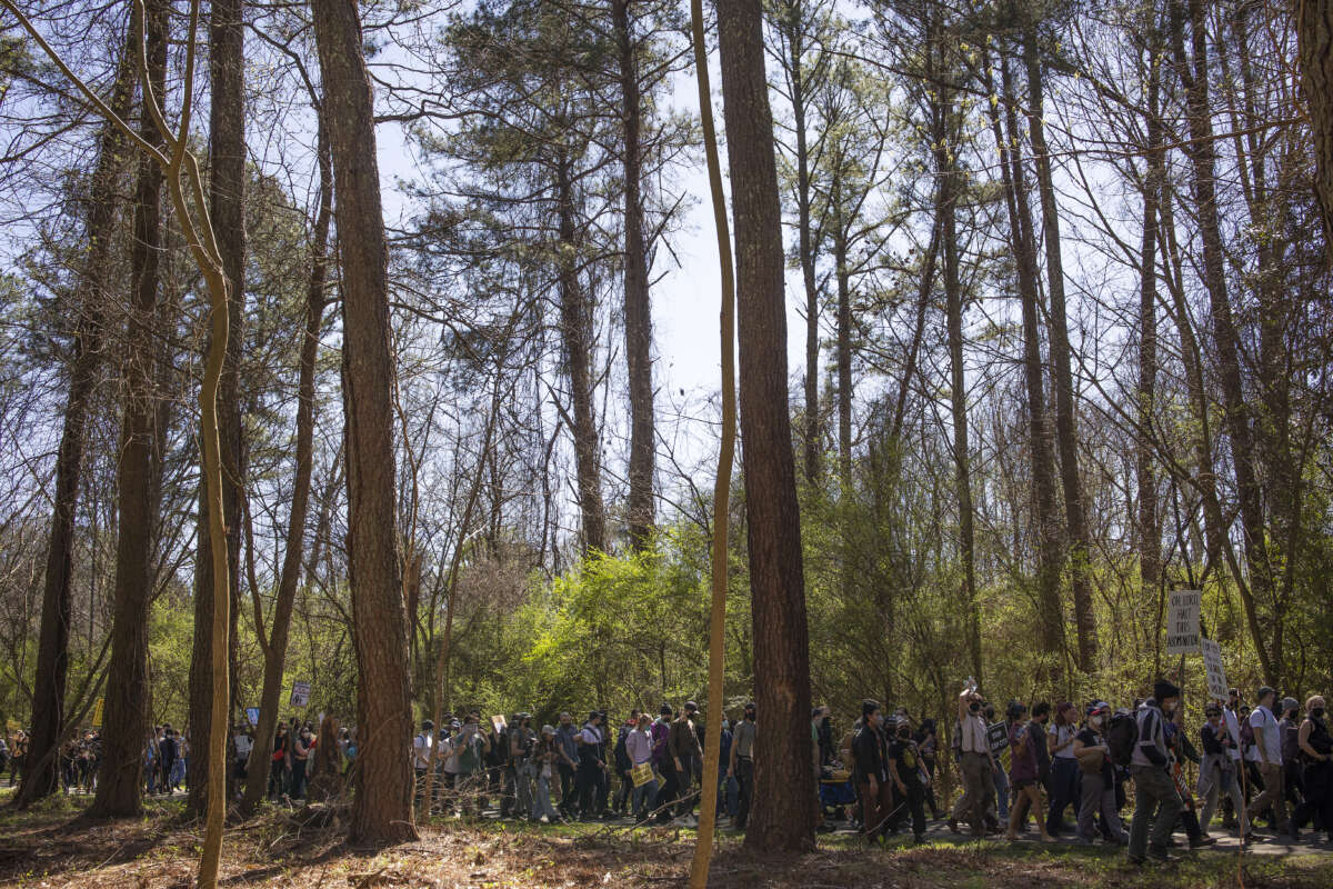 Environmental activists hold a rally and a march through the Atlanta Forest, a preserved forest Atlanta that is scheduled to be developed as a police training center, on March 4, 2023, in Atlanta, Georgia.