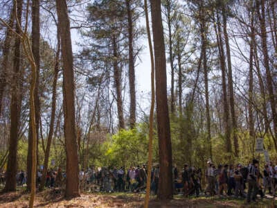 Environmental activists hold a rally and a march through the Atlanta Forest, a preserved forest Atlanta that is scheduled to be developed as a police training center, on March 4, 2023, in Atlanta, Georgia.
