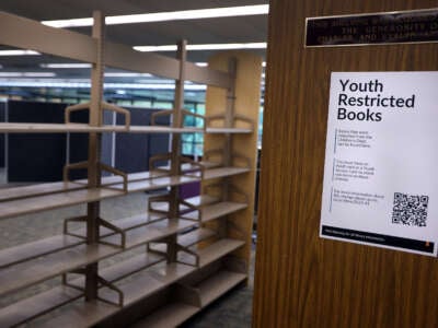 Two new rows of shelves dedicated to Youth Restricted Books sit mostly empty at the Huntington Beach Central Library in Huntington Beach, California, on February 21, 2024.