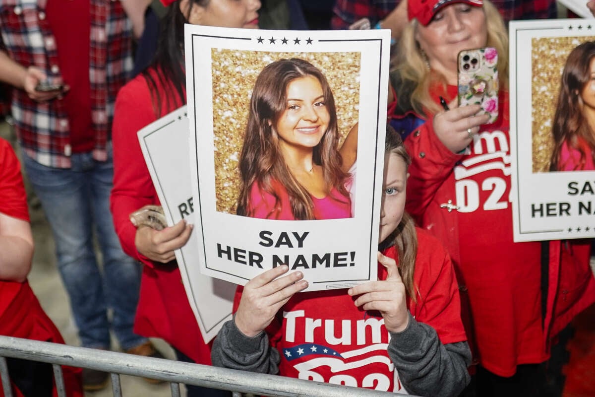 Supporters of Donald Trump hold images of Laken Riley before he speaks at a "Get Out the Vote" rally in Rome, Georgia, on March 9, 2024.