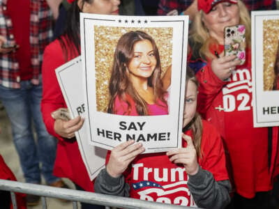 Supporters of Donald Trump hold images of Laken Riley before he speaks at a "Get Out the Vote" rally in Rome, Georgia, on March 9, 2024.