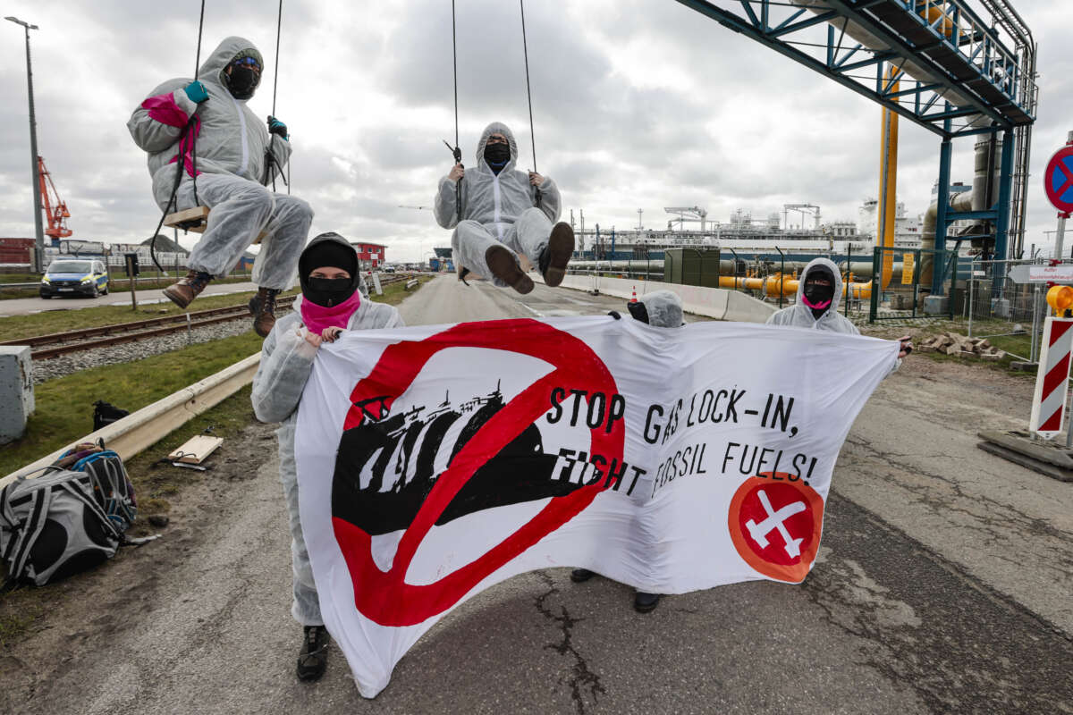 Members of the environmental group Ende Gelände block the access road to a floating LNG terminal in Brunsbüttel, Germany, on March 16, 2024.