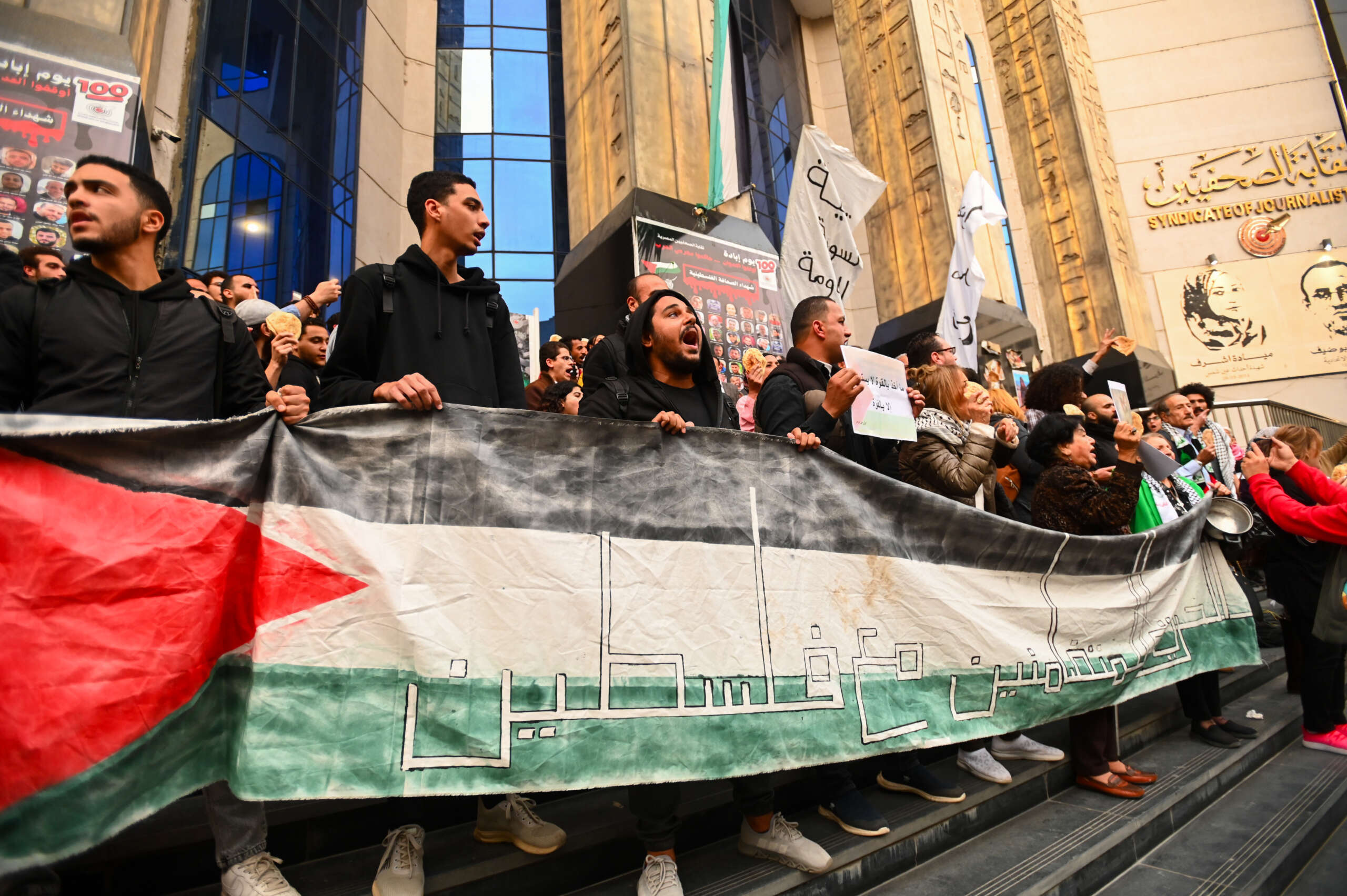 Egyptians participate in a protest in front of the Journalists Syndicate and break their fast with bread and water in protest against the starvation of the people of Gaza on March 26, 2024, in Cairo, Egypt.