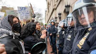 Students and pro-Palestinian activists face police as they gather outside of Columbia University to protest the university's stance on Israel on April 18, 2024 in New York City.