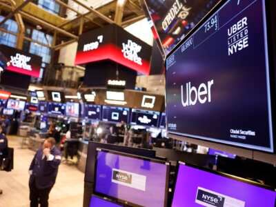 The Uber company logo is displayed on a screen at the New York Stock Exchange during morning trading on February 14, 2024 in New York City.