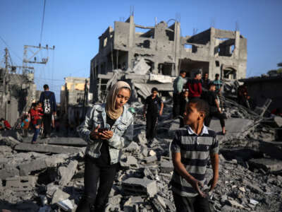 Palestinians inspect the damage in the rubble of the Al-Bashir mosque following Israeli bombardment in Deir al-Balah, central Gaza Strip, on April 2, 2024.