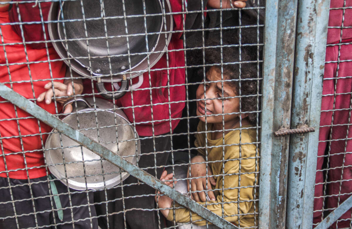 Crowd of starving Palestinians, including children, wait to receive food distributed by charity organizations amid Israel's blockade, in Jabalia refugee camp, Gaza, on March 27, 2024.