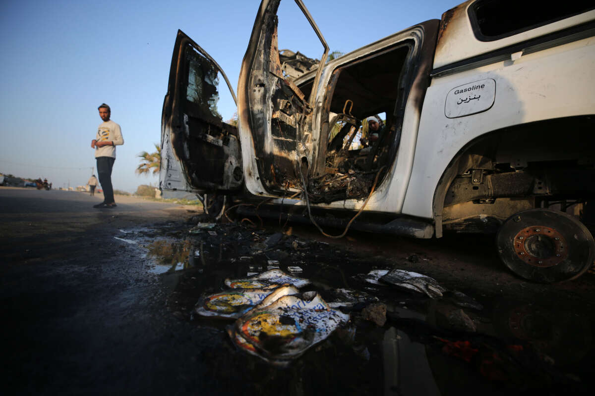 A Palestinian checks a damaged vehicle after Israeli strikes in central Gaza Strip city of Deir el-Balah, on April 2, 2024.