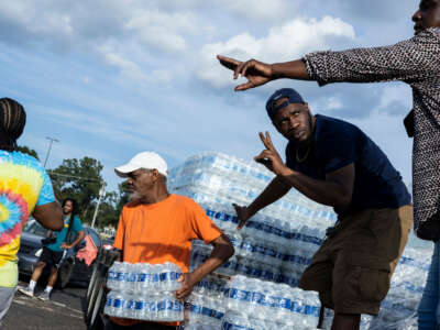 Cases of bottled water are handed out at a Mississippi Rapid Response Coalition distribution site on August 31, 2022, in Jackson, Mississippi.