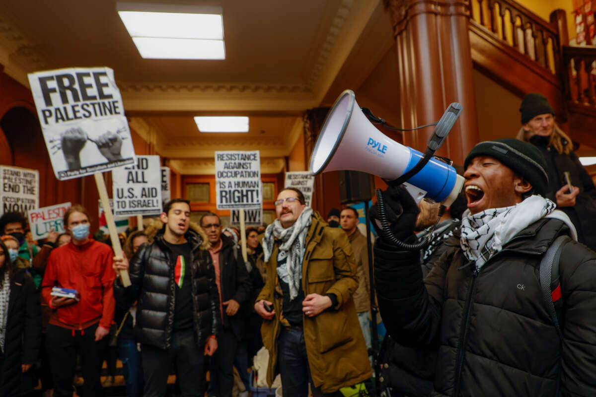 Kojo Acheampong, a Harvard student and member of African and African American Resistance Organization, speaks to pro-Palestine demonstrators in the lobby of Cambridge City Hall before their scheduled meeting on January 29, 2024, in Cambridge, Massachusetts.