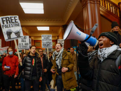 Kojo Acheampong, a Harvard student and member of African and African American Resistance Organization, speaks to pro-Palestine demonstrators in the lobby of Cambridge City Hall before their scheduled meeting on January 29, 2024, in Cambridge, Massachusetts.