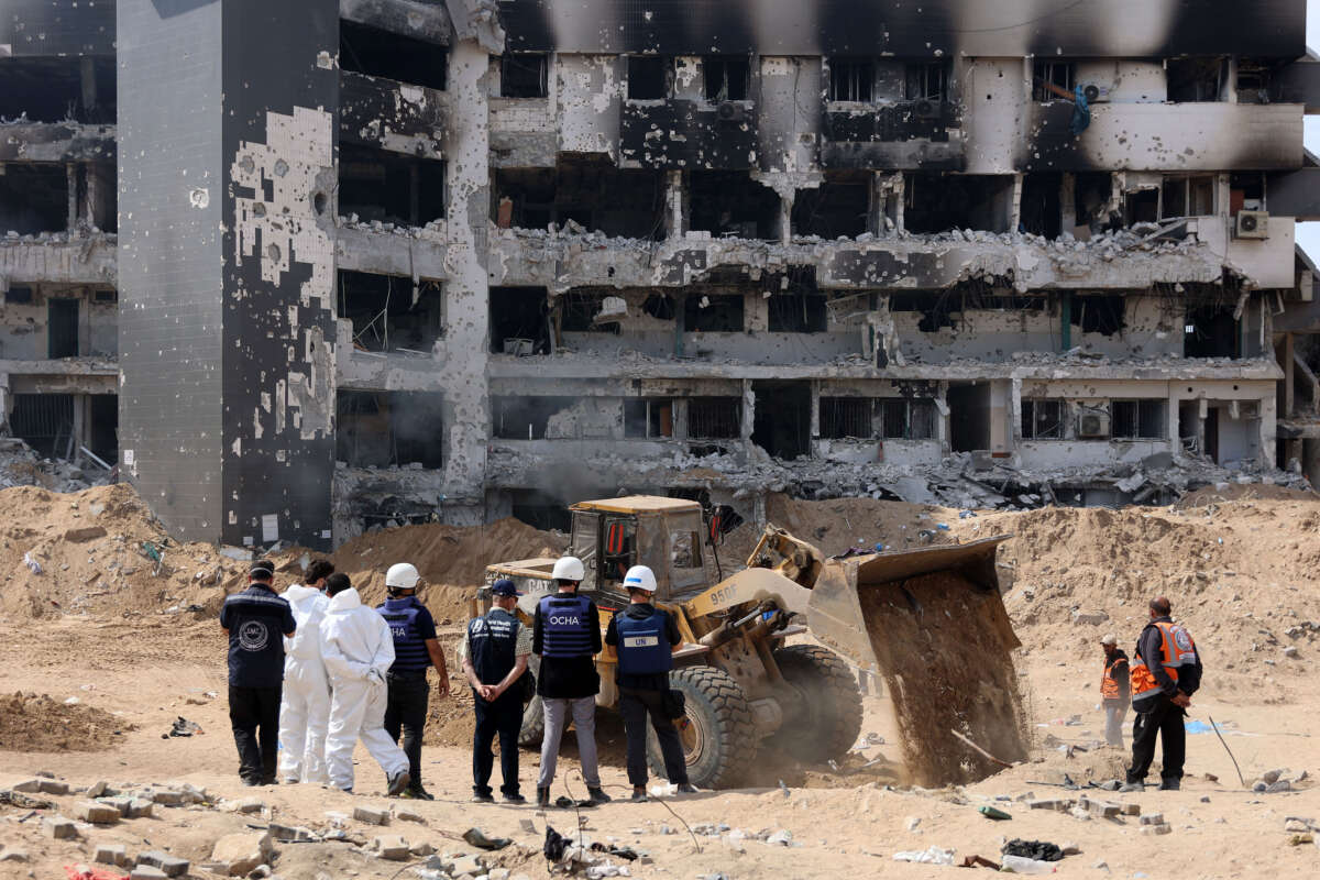 A United Nations team visits as Palestinian civil defense recovers human remains from the grounds of Al-Shifa hospital, Gaza's largest hospital, which was reduced to ruins by a two-week Israeli raid, on April 8, 2024.