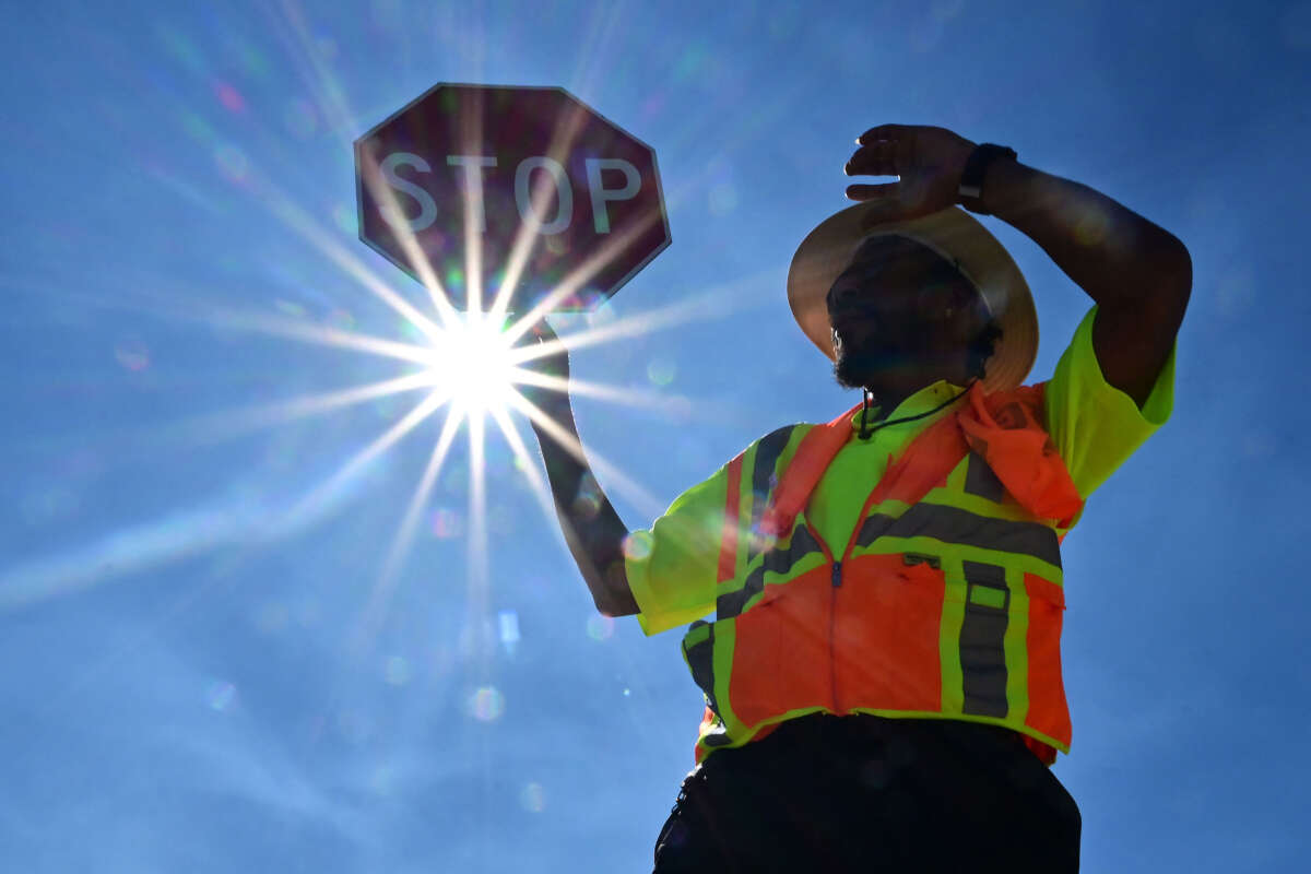 Traffic warden Rai Rogers mans his street corner during an 8-hour shift under the hot sun in Las Vegas, Nevada, on July 12, 2023, where temperatures reached 106 degrees amid an ongoing heatwave.