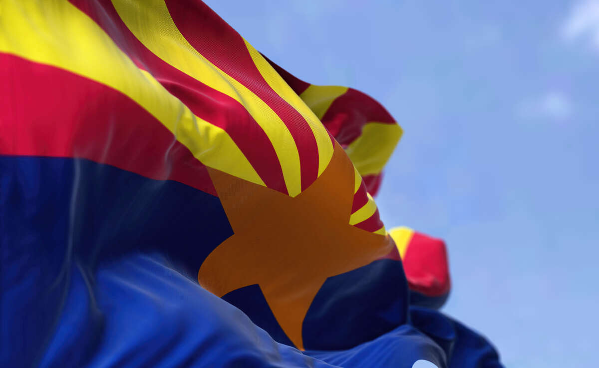 Arizona state flag flying over blue sky