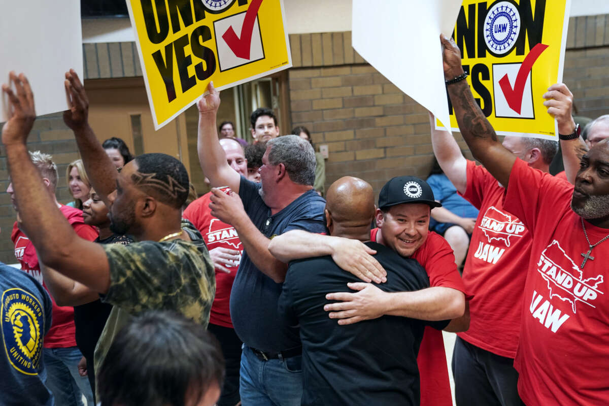 Auto workers embrace, united
