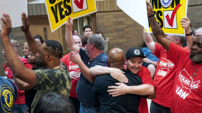 Auto workers embrace, united
