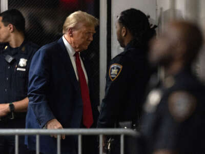 Former President Donald Trump returns from a break in his criminal trial for allegedly covering up hush money payments at Manhattan Criminal Court on April 25, 2024, in New York City.