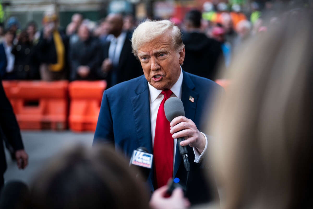 Former President Donald Trump speaks with reporters as he greets construction workers and union members at the construction site for the new JPMorgan Chase headquarters in midtown Manhattan before going to Manhattan criminal court in New York on April 25, 2024.