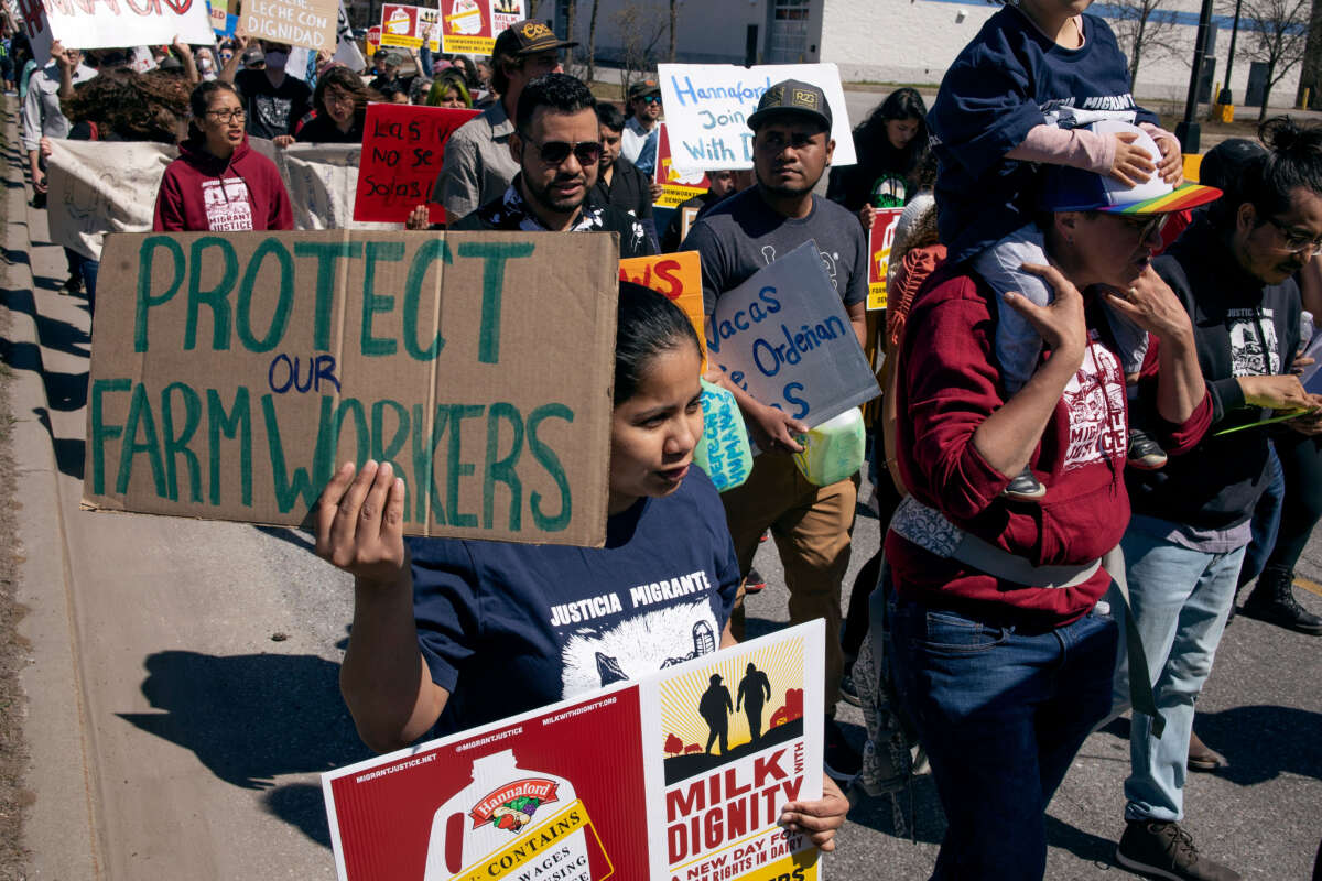 Farmworkers march to a Hannaford supermarket to protest the supermarket chain's refusal to purchase milk from dairy suppliers who have committed to a set of fair labor practices, on May 1, 2022, in Burlington, Vermont.