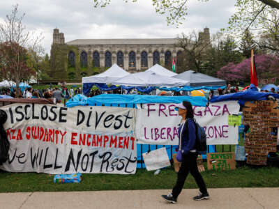 A person walks past a pro-Palestinian encampment at Northwestern University, April 28, 2024, in Evanston, Illinois.