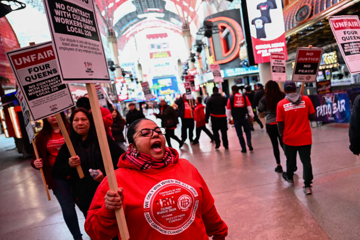 Supporters of the Culinary Workers and Bartenders Unions carry picket signs calling for a fair contract ahead of a strike deadline outside of the Four Queens Casino in downtown Las Vegas, Nevada, on February 2, 2024.