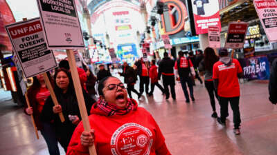 Supporters of the Culinary Workers and Bartenders Unions carry picket signs calling for a fair contract ahead of a strike deadline outside of the Four Queens Casino in downtown Las Vegas, Nevada, on February 2, 2024.