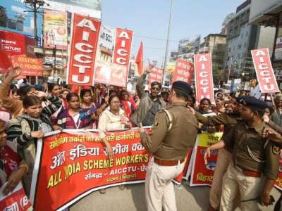 Police stop a rally of Central Trade Union Federation members during Bharat Bandh called by farmers, at Dak Bungalow crossing in Patna, India, on February 16, 2024.