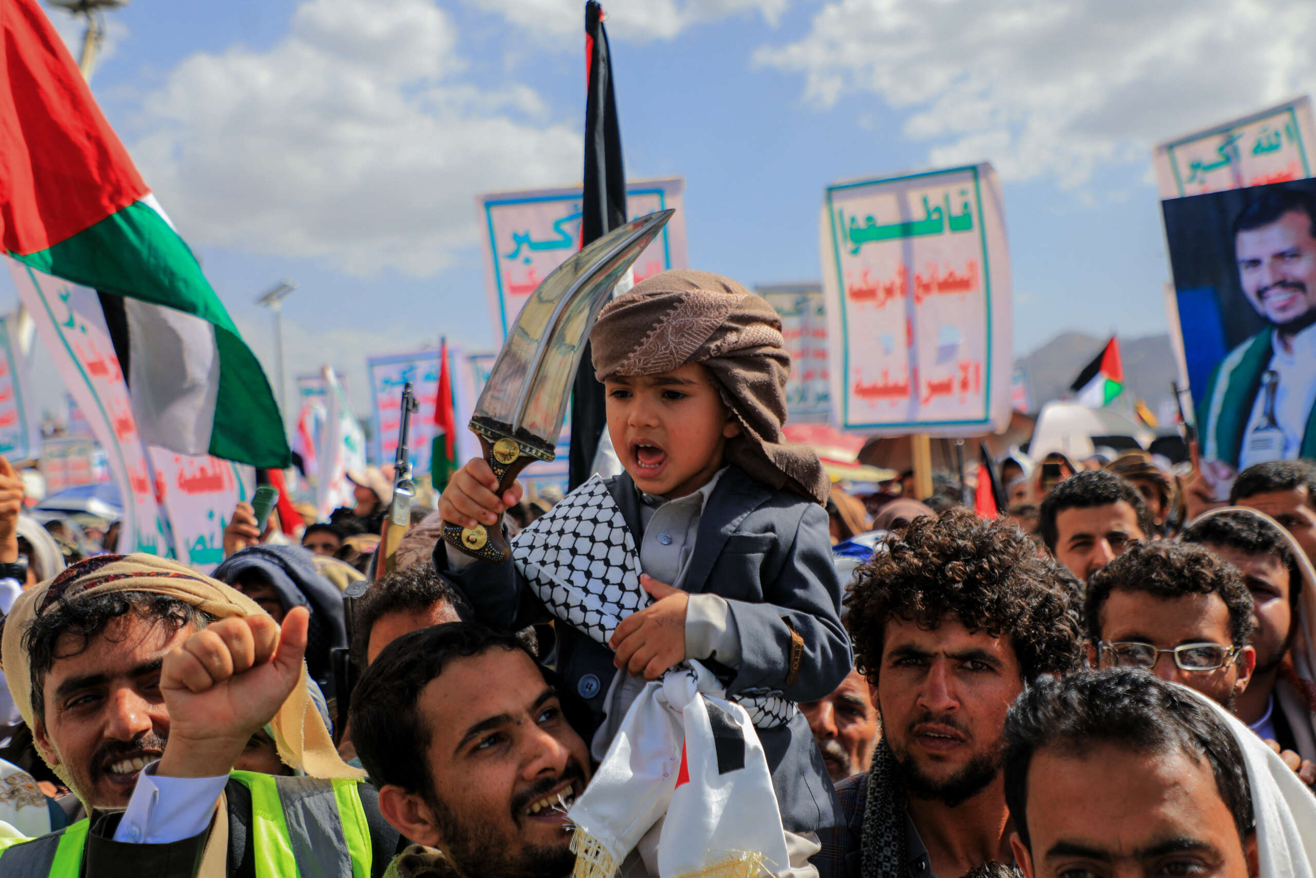 A Yemeni boy brandishes a janbiya, a traditional curved dagger, during a march in support of Palestinians in the capital Sanaa, on March 15, 2024.