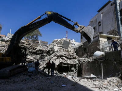 Rescue workers search in the rubble of a building annexed to the Iranian embassy a day after an Israeli air strike in Damascus, Syria, on April 2, 2024.