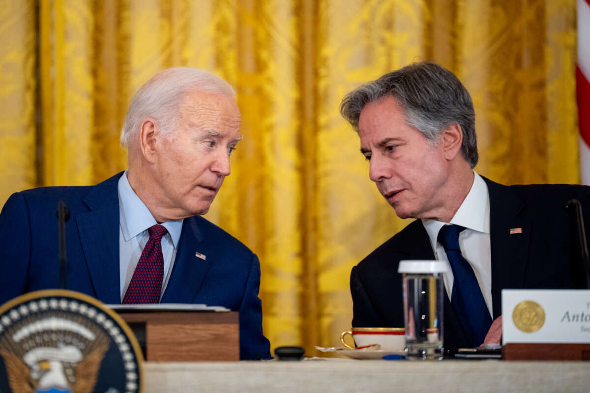 U.S. President Joe Biden speaks with Secretary of State Antony Blinken during a trilateral meeting with Japanese Prime Minister Fumio Kishida and Filipino President Ferdinand Marcos in the East Room of the White House on April 11, 2024, in Washington, D.C.