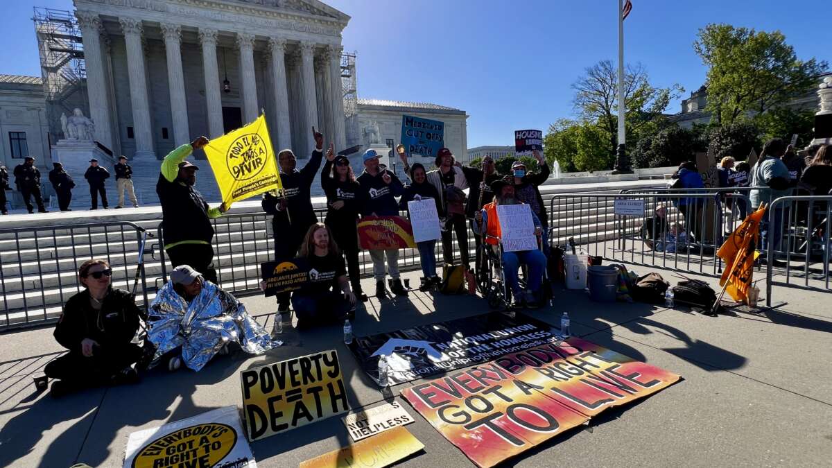 Advocates with lived homelessness experience demonstrate in front of the U.S. Supreme Court.