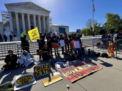 Advocates with lived homelessness experience demonstrate in front of the U.S. Supreme Court.