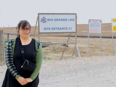 Bekah Hinojosa poses outside a planned facility slated to export fracked gas, or so-called liquefied natural gas (LNG), at the Port of Brownsville in South Texas on March 30, 2024. The terminal site is one of two facilities that are still moving forward at the port despite the Biden administration's announced LNG permitting freeze.