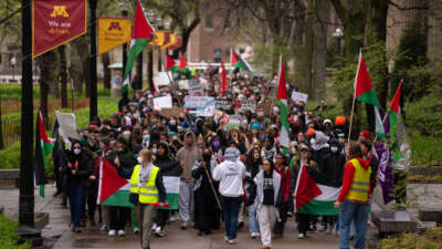 Demonstrators march on the Northrop Mall to call for a ceasefire in Gaza before setting up an encampment on the lawn on April 29, 2024, on the University of Minnesota campus in Minneapolis.