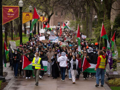 Demonstrators march on the Northrop Mall to call for a ceasefire in Gaza before setting up an encampment on the lawn on April 29, 2024, on the University of Minnesota campus in Minneapolis.
