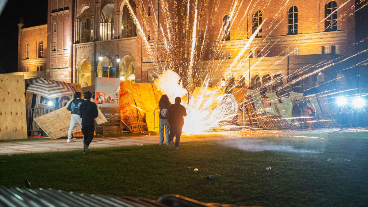 Pro-Israel counter-protesters lay siege on a Gaza solidarity encampment at UCLA with fireworks in Los Angeles, California, on May 1, 2024.