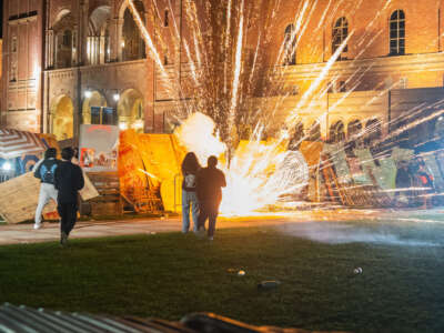 Pro-Israel counter-protesters lay siege on a Gaza solidarity encampment at UCLA with fireworks in Los Angeles, California, on May 1, 2024.