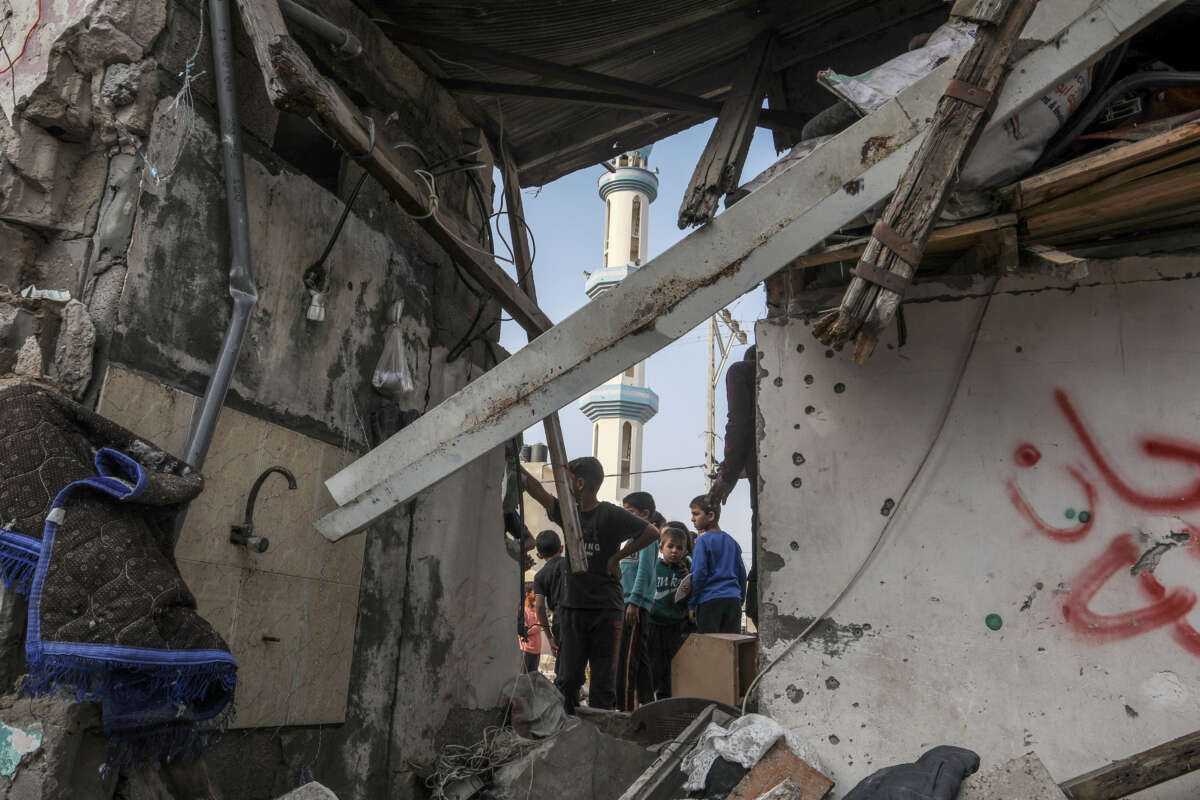 Palestinians, including children, collect remaining belongings from the rubble of destroyed houses after Israeli attacks on the house belonging to the Abu Gali family as Israeli attacks continue on Gaza Strip on May 1, 2024, in Rafah, Gaza.