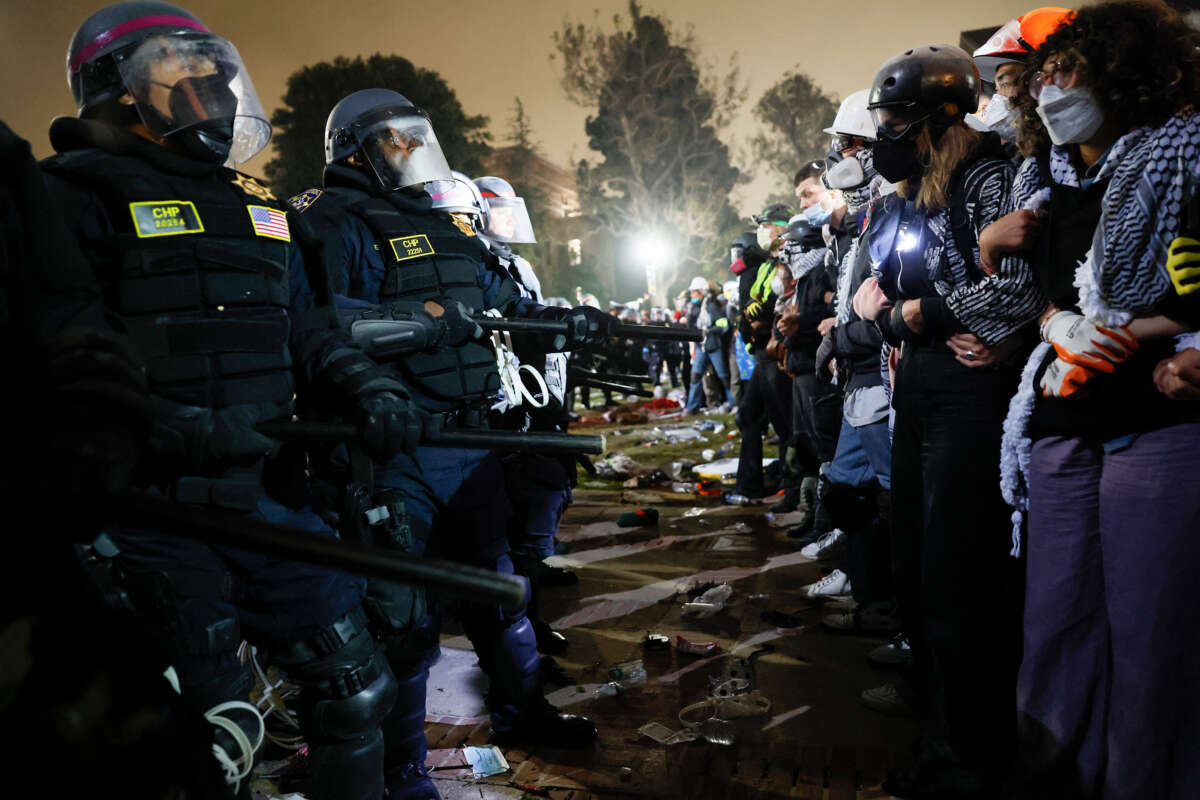 Police face off with pro-Palestinian students after destroying part of the encampment barricade on the campus of the University of California, Los Angeles (UCLA) in Los Angeles, California, on May 2, 2024.