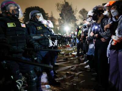 Police face off with pro-Palestinian students after destroying part of the encampment barricade on the campus of the University of California, Los Angeles (UCLA) in Los Angeles, California, on May 2, 2024.
