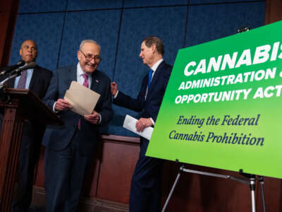 Senate Majority Leader Charles Schumer (center), Sens. Cory Booker (left), and Ron Wyden conduct a news conference on reintroduction of the Cannabis Administration and Opportunity Act (CAOA), in the Capitol Visitor Center on May 1, 2024.