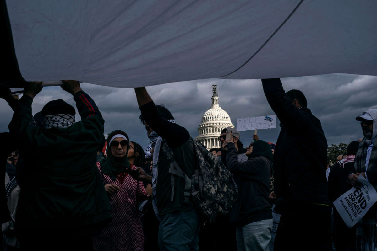 Protesters hold a Palestinian flag while joining a demonstration near the Capitol building in Washington, D.C., on October 21, 2023.