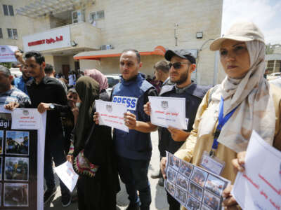 Press members gather to stage a demonstration in front of the Aqsa Martyrs Hospital to commemorate World Press Freedom Day in Deir-Al Balah, Gaza, on May 2, 2024.