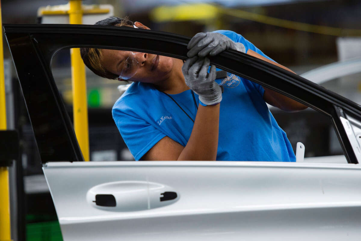 Employees install parts on a door for the Mercedes-Benz C-Class at the Mercedes-Benz U.S. International factory in Vance, Alabama, on June 8, 2017.