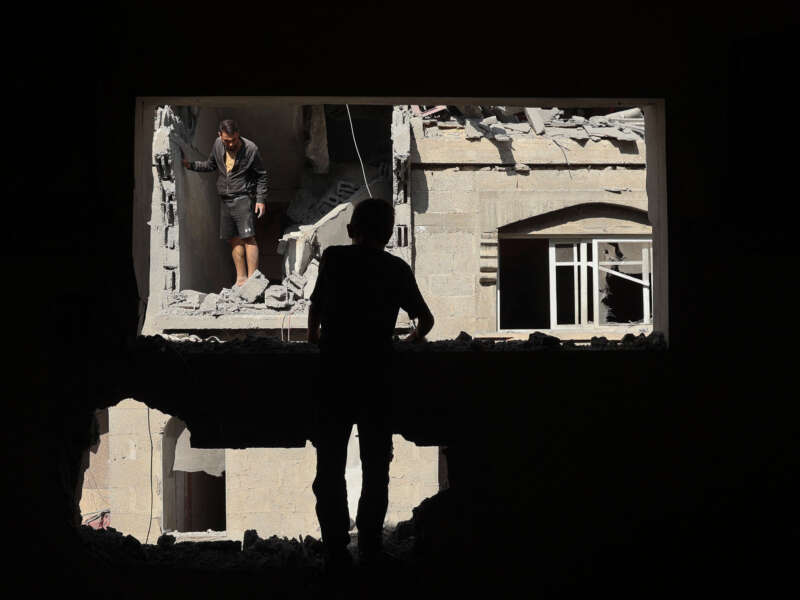 Palestinians inspect the damage around the Derby family house struck in Israeli bombardment of Rafah's Tal al-Sultan district in the southern Gaza Strip on May 7, 2024.